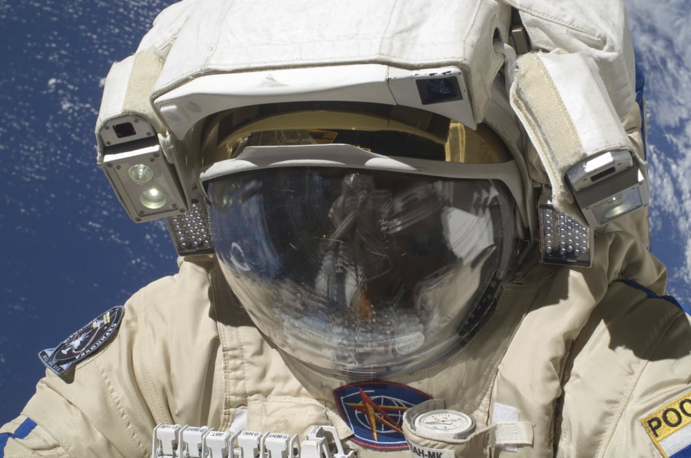A Russian cosmonaut wearing a Russian Orlan spacesuit during a spacewalk Canvas Art - Stocktrek Images (34 x 23)