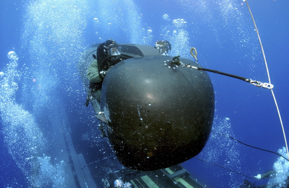 A SEAL Delivery Vehicle Team member launching a SEAL Delivery Vehicle from the back of USS Philadelphia Canvas Art - Stocktrek Images (34 x 23)