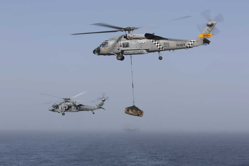 A SH-60J Seahawk and a MH-60S during a vertical replenishment Canvas Art - Gert KromhoutStocktrek Images (35 x 23)