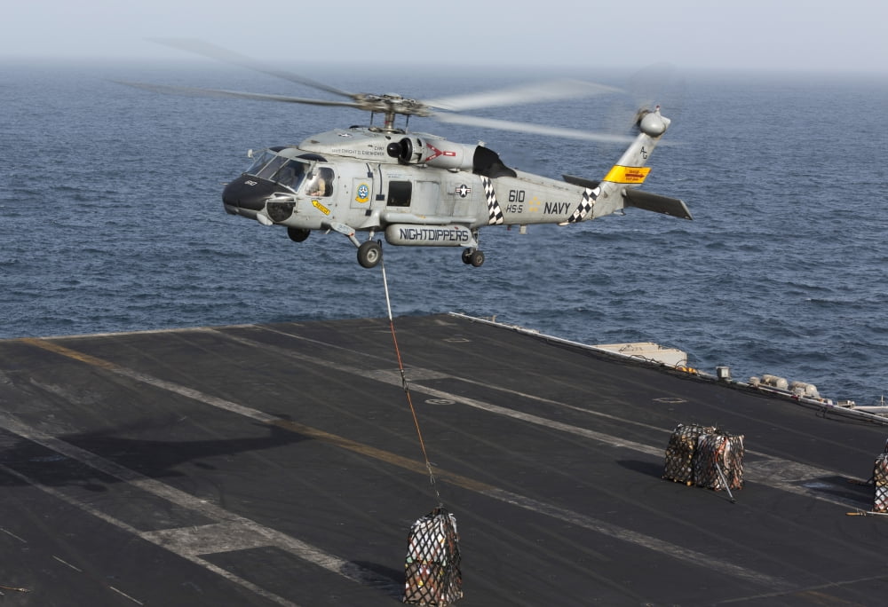 A SH-60J Seahawk conducts a vertical replenishment with USNS Supply Canvas Art - Gert KromhoutStocktrek Images (17 x 12)