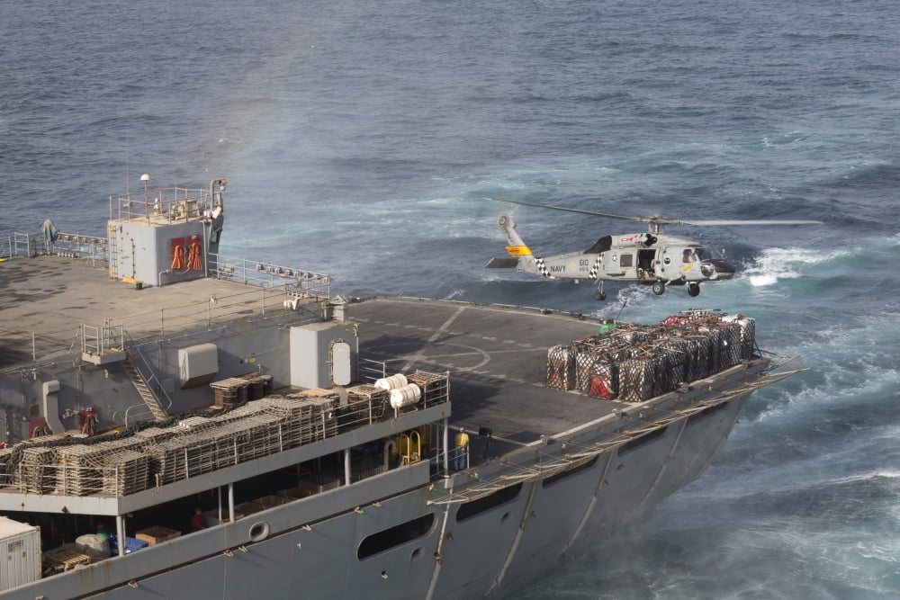 A SH-60J Seahawk conducts a vertical replenishment with USNS Supply Canvas Art - Gert KromhoutStocktrek Images (18 x 12)