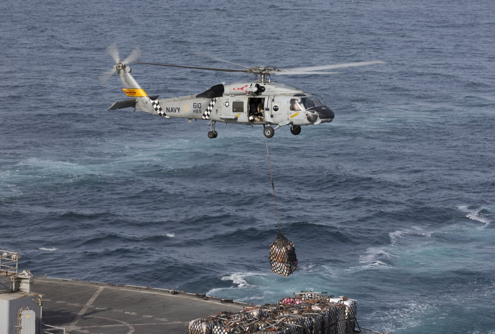 A SH-60J Seahawk conducts a vertical replenishment with USNS Supply Canvas Art - Gert KromhoutStocktrek Images (18 x 12)