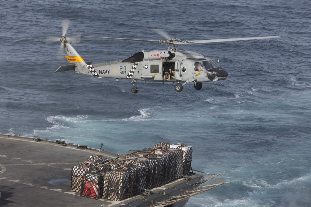 A SH-60J Seahawk conducts a vertical replenishment with USNS Supply Canvas Art - Gert KromhoutStocktrek Images (18 x 12)