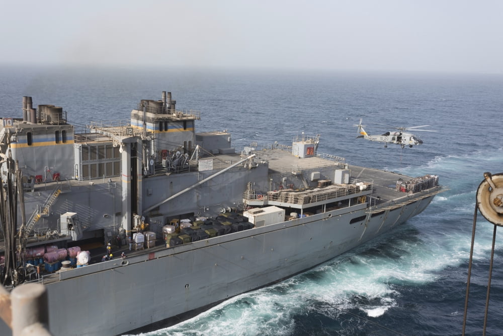 A SH-60J Seahawk conducts a vertical replenishment with USNS Supply Canvas Art - Gert KromhoutStocktrek Images (18 x 12)