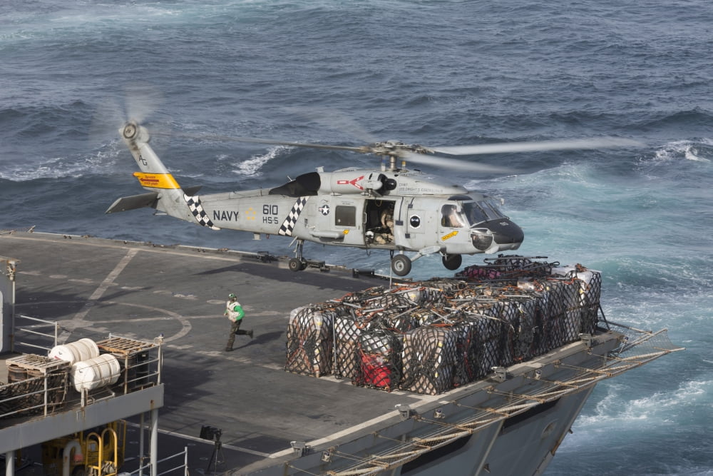 A SH-60J Seahawk conducts a vertical replenishment with USNS Supply Canvas Art - Gert KromhoutStocktrek Images (35 x 24)