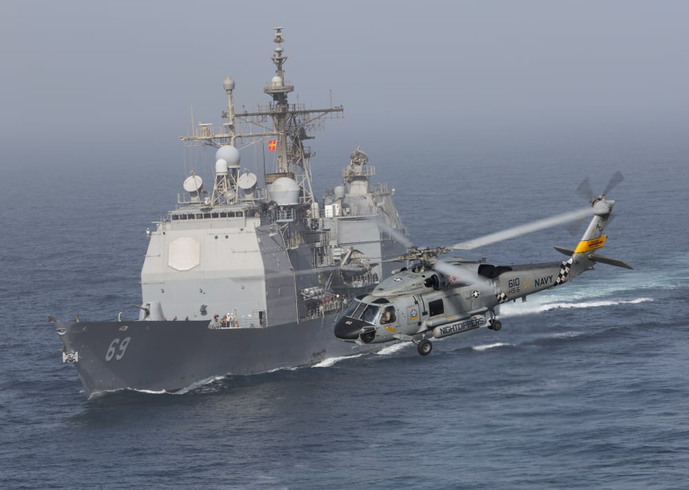 A SH-60J Seahawk flys by USS Vicksburg during a vertical replenishment Canvas Art - Gert KromhoutStocktrek Images (34 x 24)
