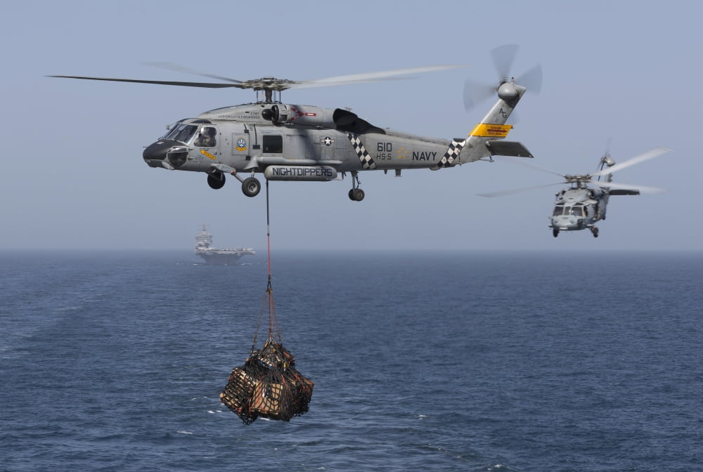 A SH-60J Seahawk transfers cargo during a vertical replenishment Canvas Art - Gert KromhoutStocktrek Images (17 x 12)