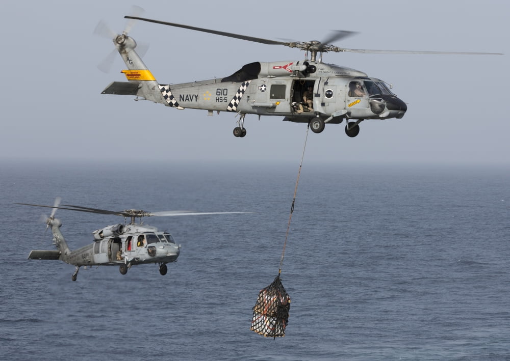 A SH-60J Seahawk transfers cargo during a vertical replenishment Canvas Art - Gert KromhoutStocktrek Images (17 x 12)