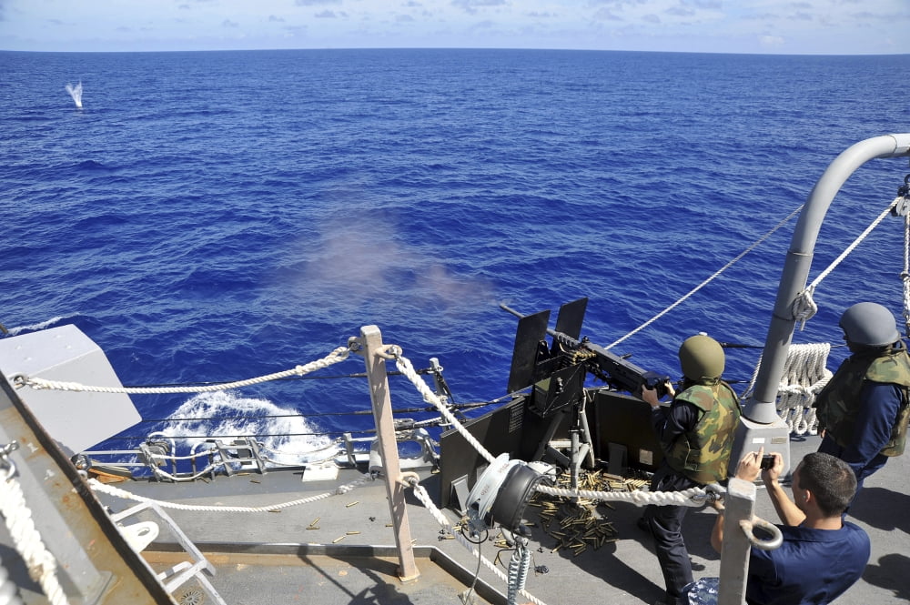 A Sailor fires a 50 caliber machine gun aboard USS McCampbell Canvas Art - Stocktrek Images (35 x 23)