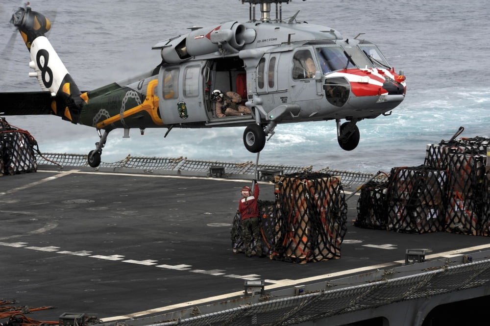 A Sailor hooks cargo to an MH-60S Sea Hawk helicopter Canvas Art - Stocktrek Images (35 x 23)