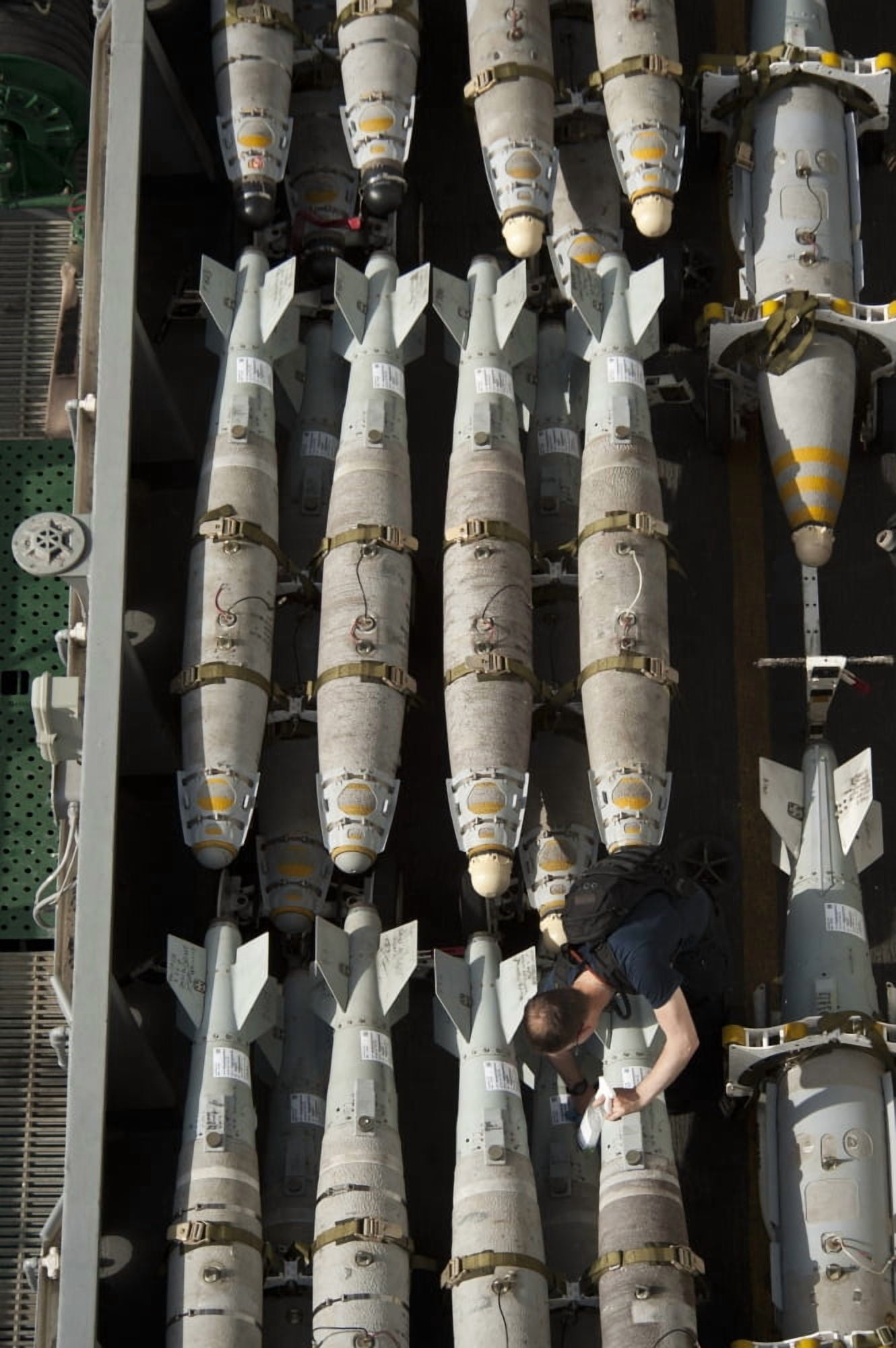 A Sailor maintains and cleans ordnance aboard USS Nimitz Canvas Art - Stocktrek Images (23 x 35)
