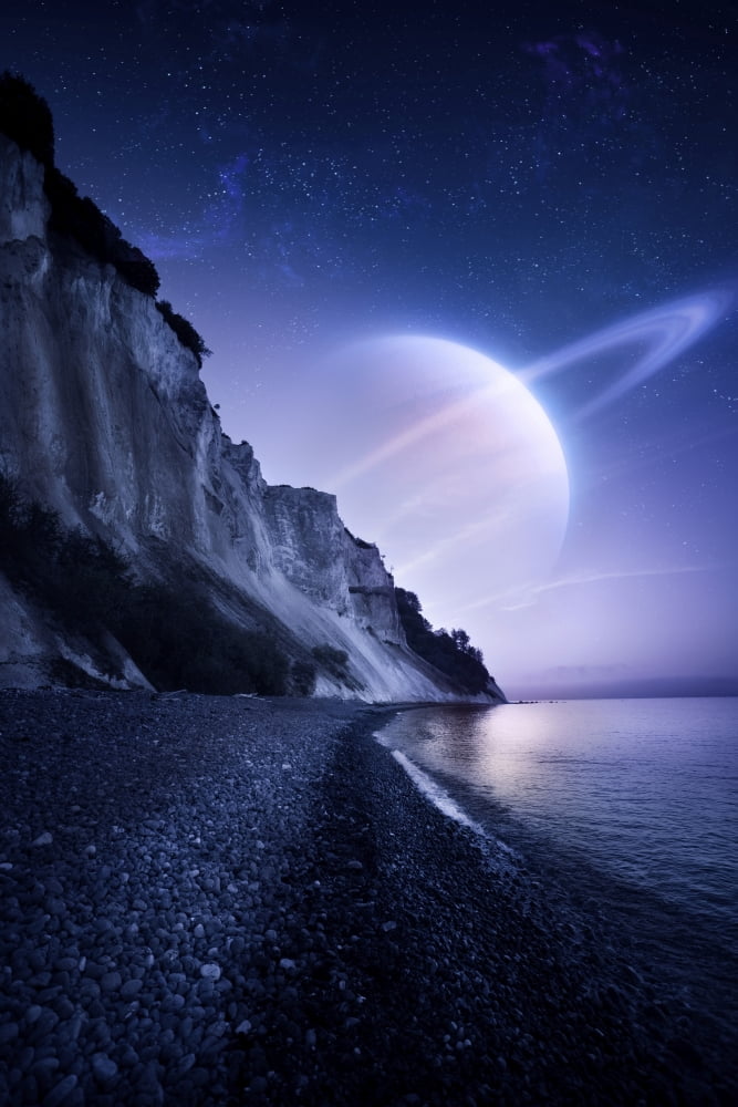 A Saturn-like planet hovers over a tranquil sea and Mons Klint cliffs Denmark Canvas Art - Evgeny KuklevStocktrek Images (23 x 35)