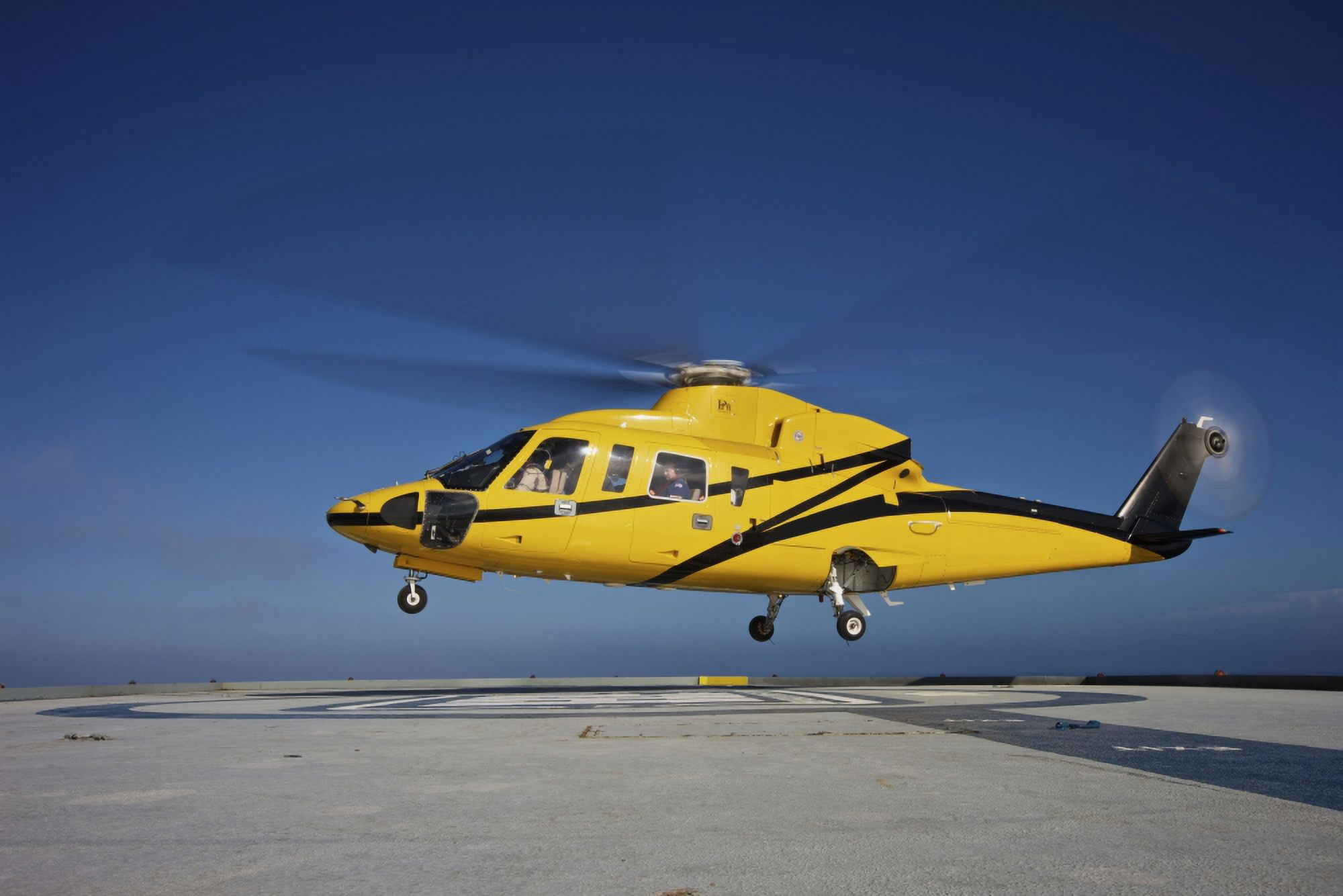 A Sikorsky S-76 utility helicopter taking off from an oil rig Canvas Art - Terry MooreStocktrek Images (35 x 24)