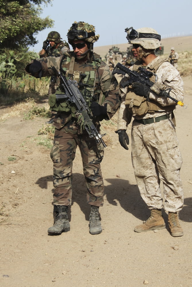 A Spanish Marine points out an improvised explosive device indicator to a US Marine Canvas Art - Stocktrek Images (23 x 34)
