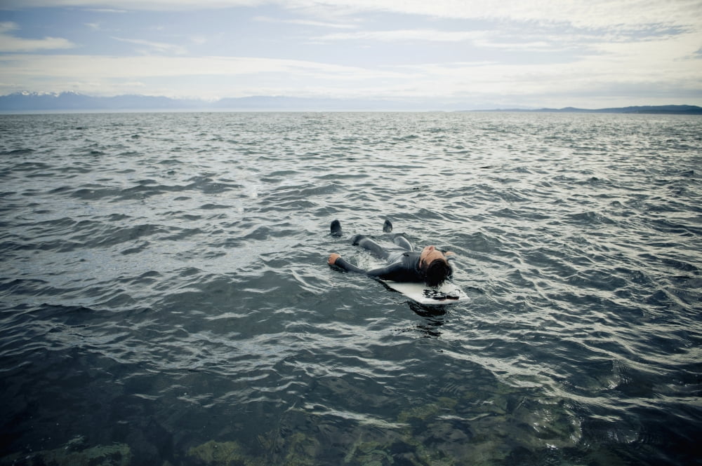 A Surfer Lays On His Back On His Surfboard In The Water Victoria British Columbia Canada Canvas Art - Helene Cyr Design Pics (19 x 12)