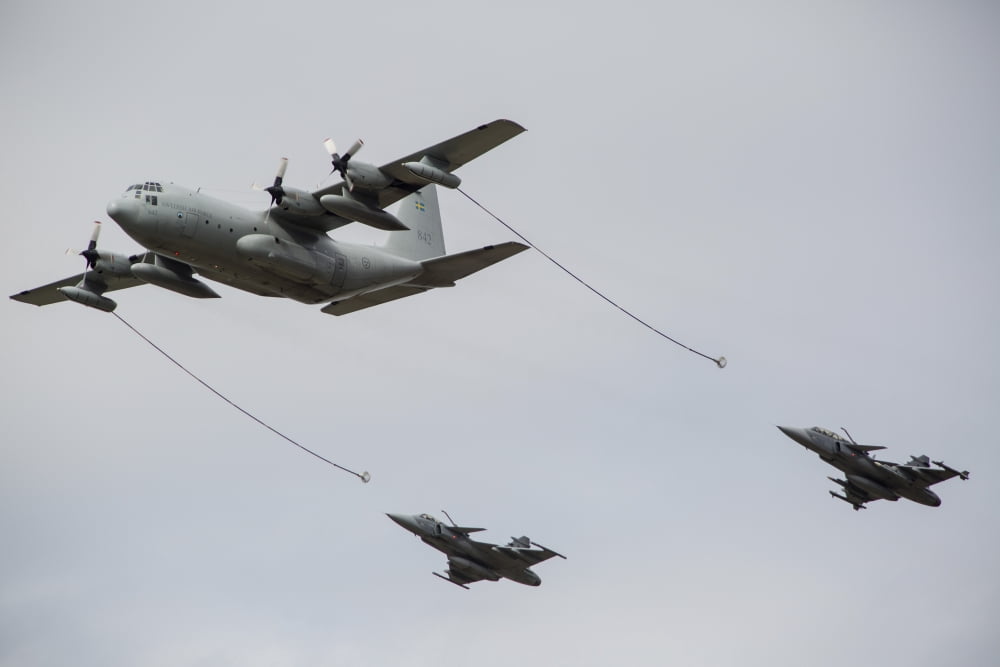 A Swedish Air Force C-130E Hercules with two Czech Air Force Gripens in tow Canvas Art - Timm ZiegenthalerStocktrek Images (17 x 12)
