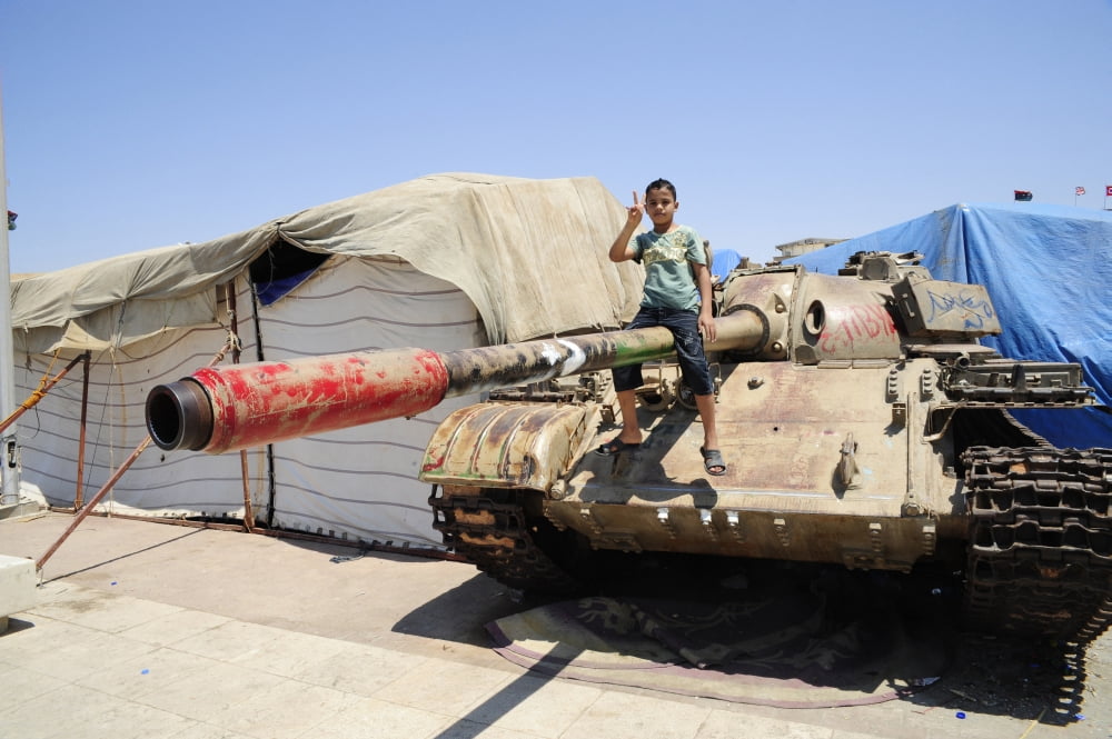 A T-55 tank with two children playing on it in Benghazi Libya Canvas Art - Andrew ChittockStocktrek Images (18 x 12)