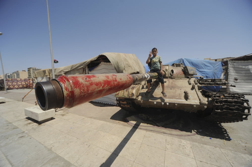 A T-55 tank with two children playing on it in Benghazi Libya Canvas Art - Andrew ChittockStocktrek Images (18 x 12)
