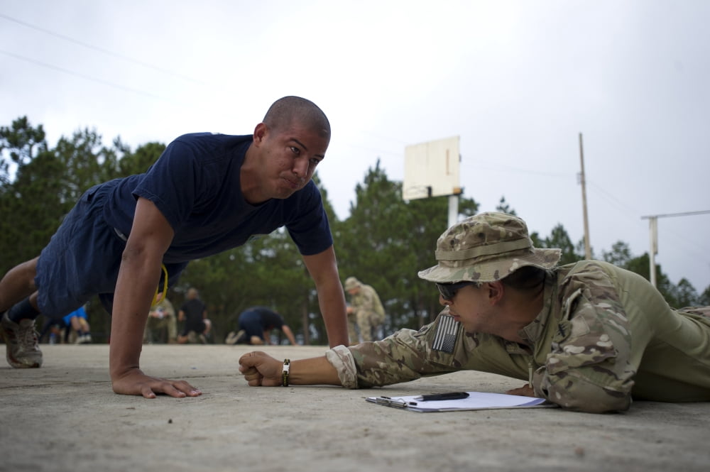 A TIGRES commando conducts push-ups in front of a Green Beret Canvas Art - Stocktrek Images (34 x 23)