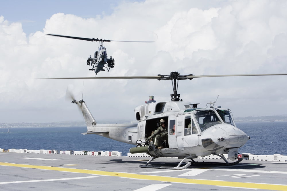 A UH-1N Huey and an AH-1W Super Cobra land on flight deck of USS Essex Canvas Art - Stocktrek Images (35 x 23)