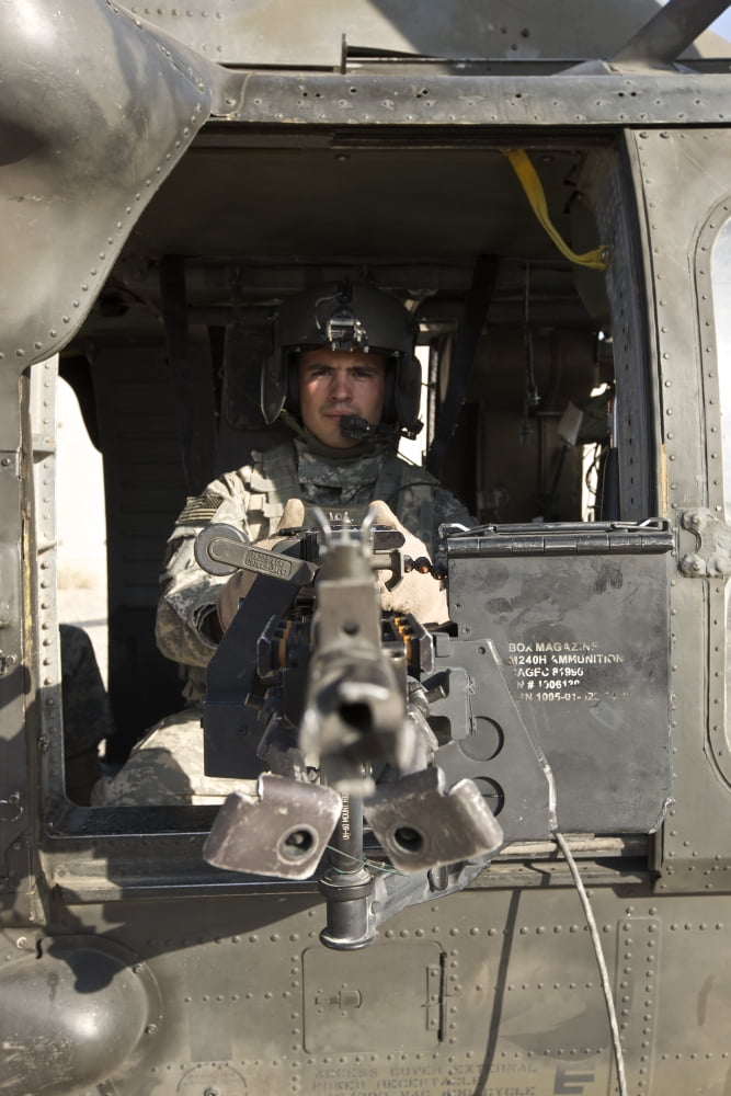 A UH-60 Black Hawk door gunner manning a M240B machine gun Canvas Art - Terry MooreStocktrek Images (23 x 35)
