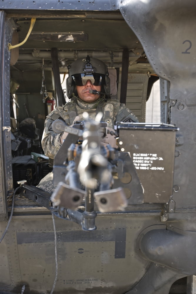 A UH-60 Black Hawk door gunner manning a M240B machine gun Canvas Art - Terry MooreStocktrek Images (23 x 35)