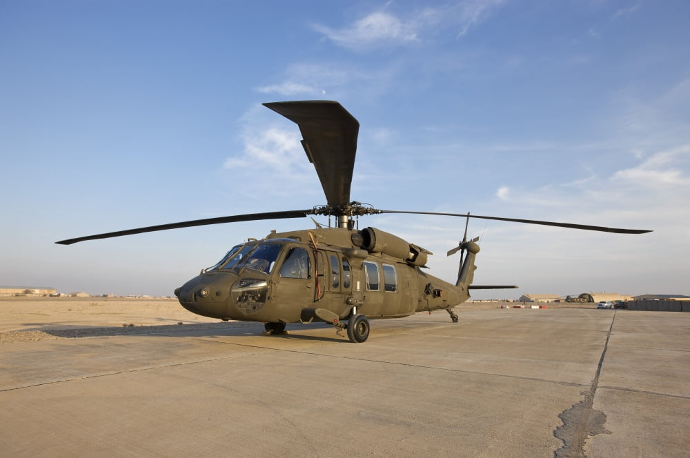 A UH-60 Black Hawk helicopter at Camp Speicher Iraq Canvas Art - Terry MooreStocktrek Images (18 x 12)