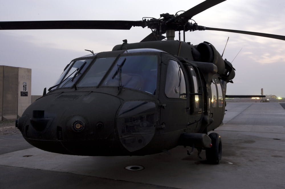 A UH-60 Black Hawk helicopter on the flight line at dusk in Tikrit Iraq Canvas Art - Terry MooreStocktrek Images (35 x 23)