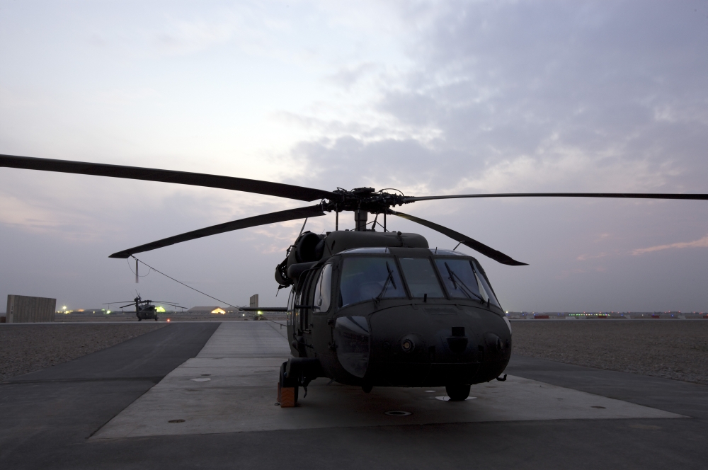 A UH-60 Black Hawk helicopter on the flight line at dusk in Tikrit Iraq Canvas Art - Terry MooreStocktrek Images (35 x 23)