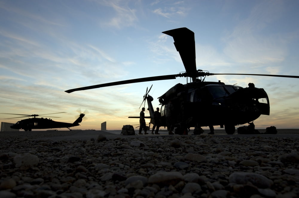 A UH-60 Black Hawk helicopter on the flight line at sunset Canvas Art - Terry MooreStocktrek Images (18 x 12)