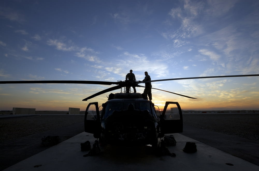 A UH-60 Black Hawk helicopter on the flight line at sunset Canvas Art - Terry MooreStocktrek Images (18 x 12)