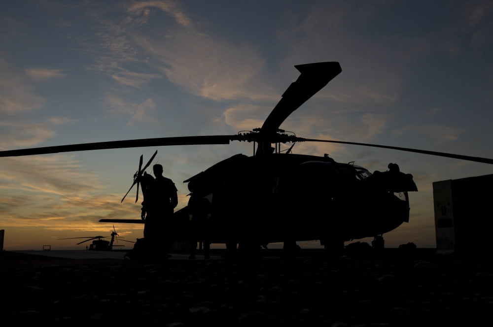 A UH-60 Black Hawk helicopter on the flight line at sunset Canvas Art - Terry MooreStocktrek Images (18 x 12)