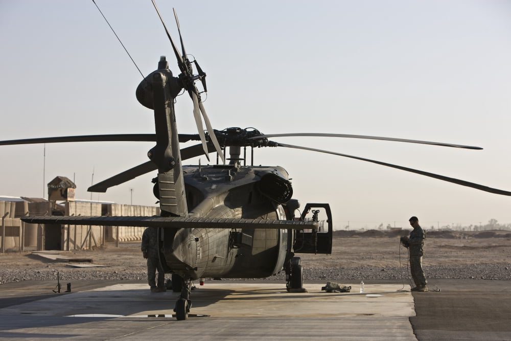 A UH-60 Black Hawk helicopter parked at Camp Speicher Iraq Canvas Art - Terry MooreStocktrek Images (35 x 23)