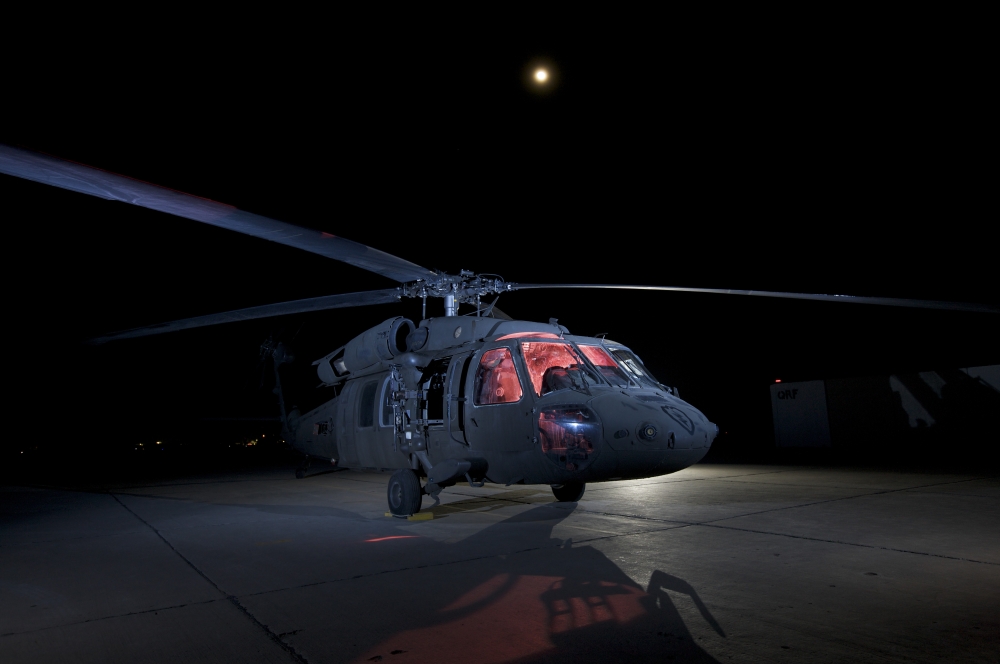A UH-60 Black Hawk helicopter parked on the flight line under a full moon Canvas Art - Terry MooreStocktrek Images (17 x 12)