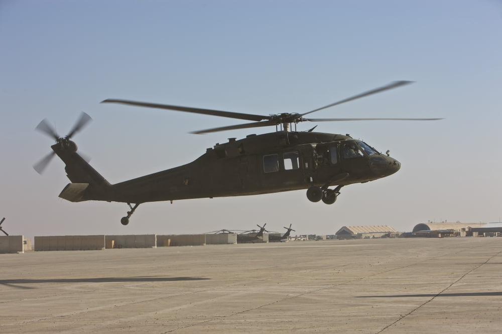 A UH-60 Black Hawk landing at a military base in Iraq Canvas Art - Terry MooreStocktrek Images (35 x 23)
