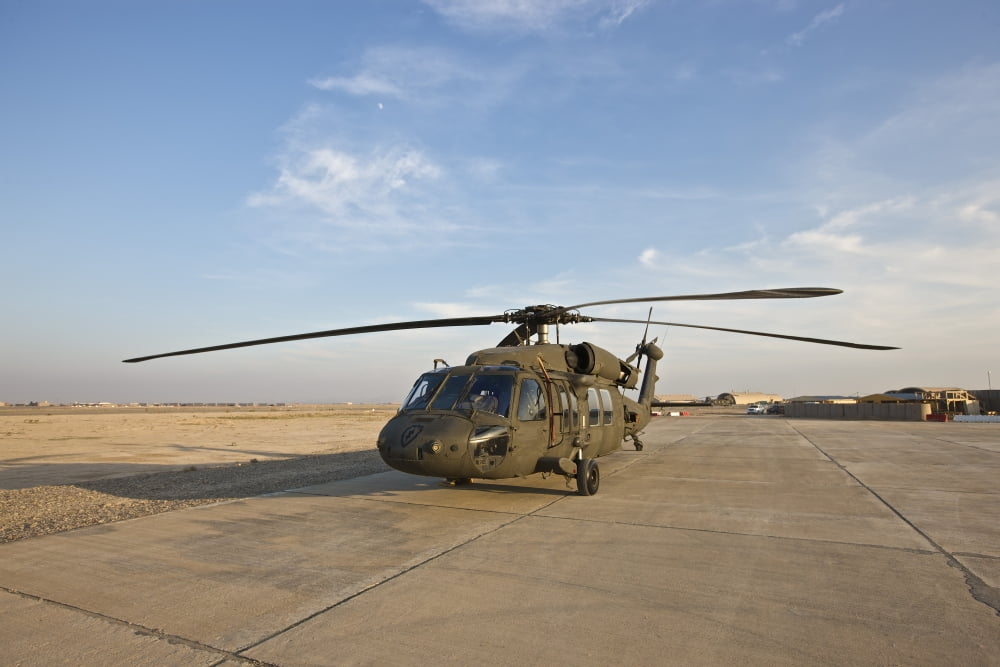 A UH-60 Black Hawk parked at a military base in Tikrit Iraq Canvas Art - Terry MooreStocktrek Images (18 x 12)