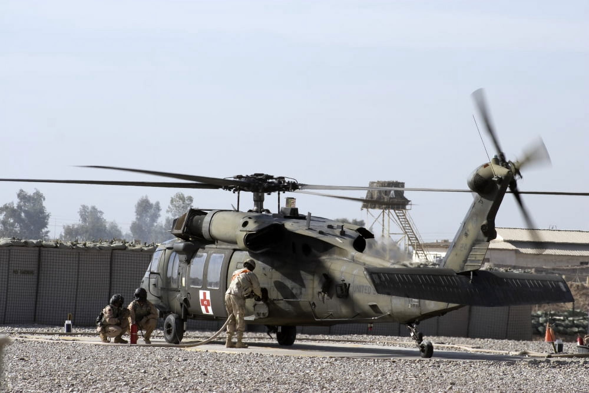 A UH-60 Blackhawk Medivac helicopter refuels at Camp Warhorse after a mission Canvas Art - Terry MooreStocktrek Images (35 x 23)