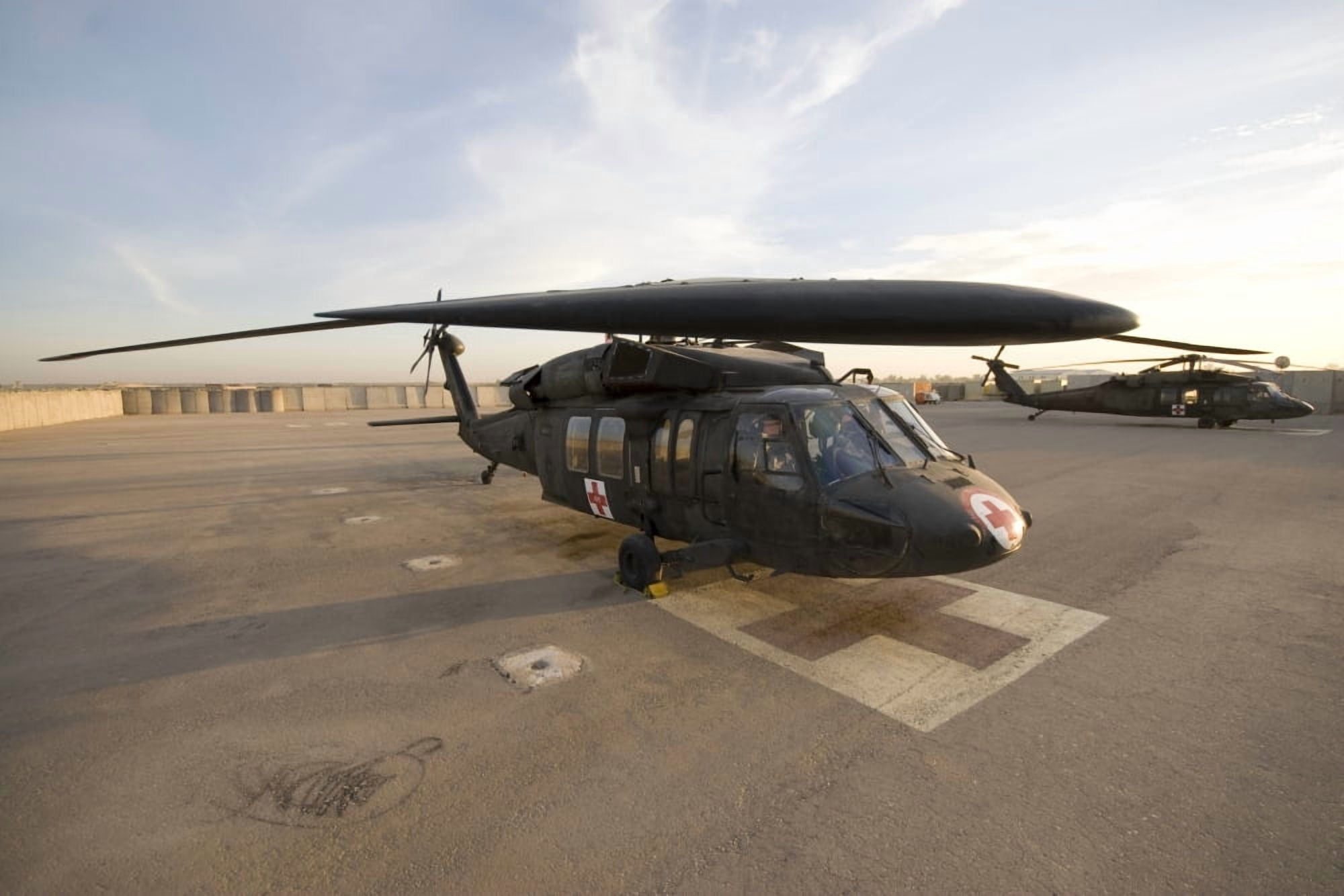 A UH-60 Blackhawk Medivac helicopter sits on the flight deck at Camp Warhorse Canvas Art - Terry MooreStocktrek Images (35 x 23)
