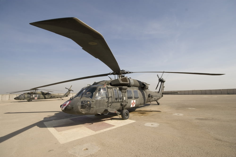 A UH-60 Blackhawk Medivac helicopter sits on the flight deck at Camp Warhorse Canvas Art - Terry MooreStocktrek Images (35 x 23)