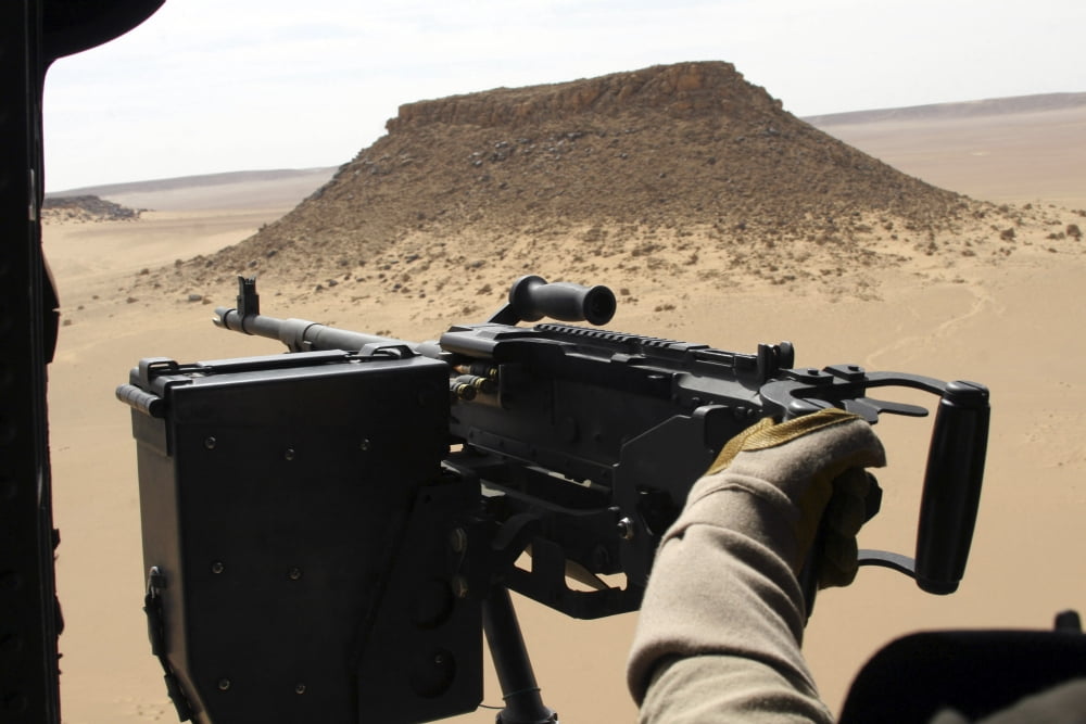 A UH-60 Blackhawk crew chief holds an M240G medium machine gun Canvas Art - Stocktrek Images (34 x 23)