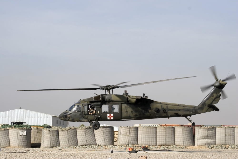A UH-60 Blackhawk prepares to land at Camp Warhorse to refuel Canvas Art - Terry MooreStocktrek Images (35 x 23)