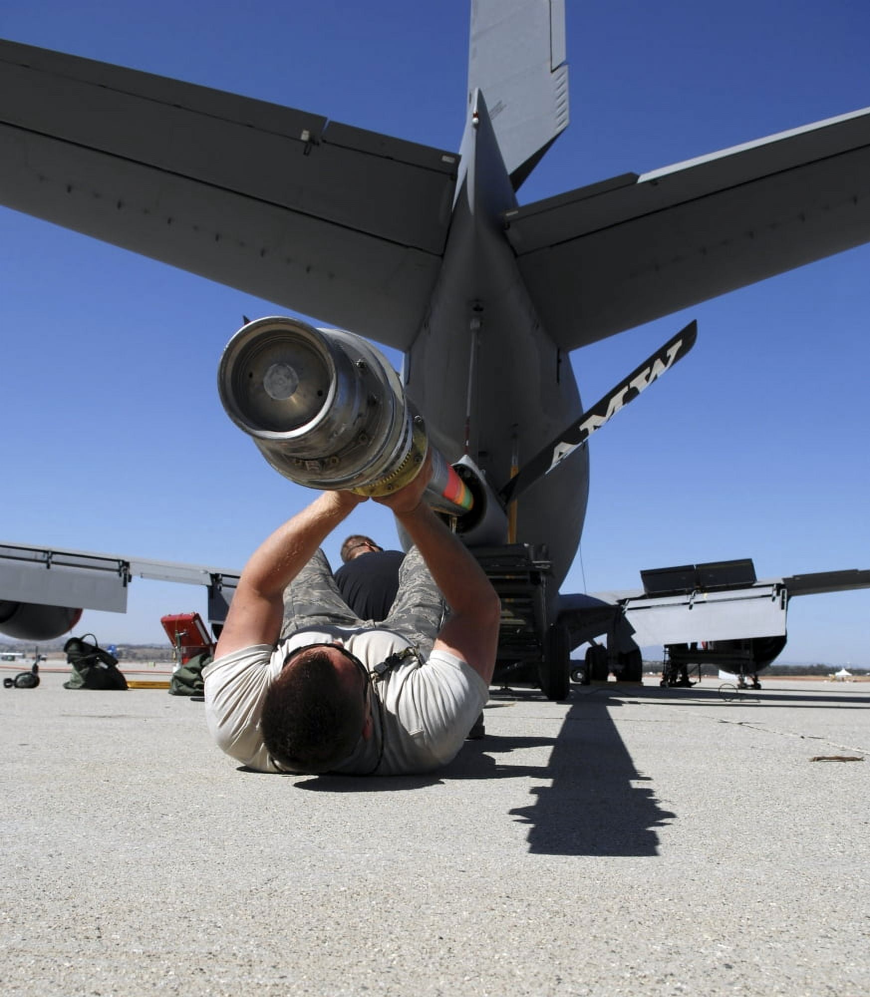 A US Air Force Airman lifts the boom of a KC-135 Stratotanker Canvas Art - Stocktrek Images (26 x 30)