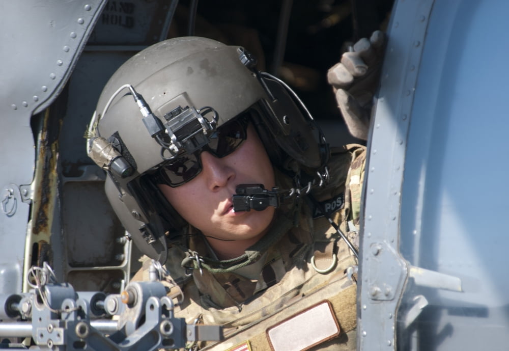 A US Air Force Airman peers out the side of a HH-60 Pave Hawk Canvas Art - Stocktrek Images (35 x 24)