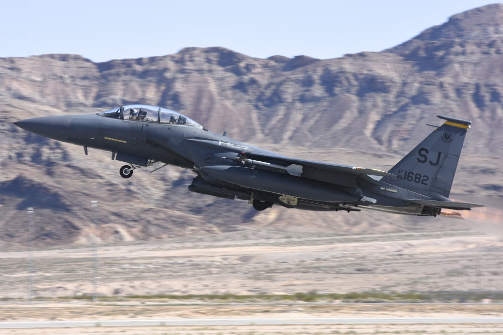 A US Air Force F-15E Strike Eagle taking off from Nellis Air Force Base Nevada Canvas Art - Riccardo NiccoliStocktrek Images (17 x 12)
