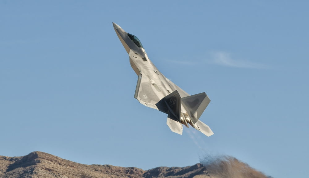 A US Air Force F-22 Raptor takes off from Nellis Air Force Base Nevada Canvas Art - Giovanni CollaStocktrek Images (19 x 11)