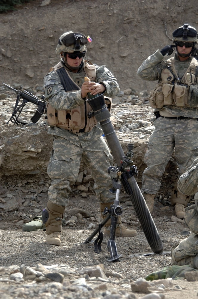 A US Army Soldier loads a mortar tube Canvas Art - Stocktrek Images (23 x 34)