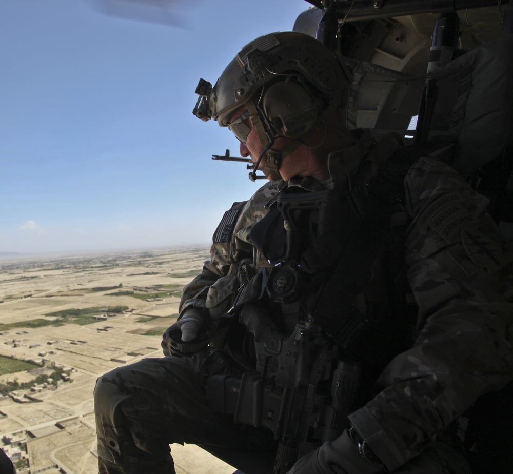 A US Army Special Forces Soldier looks out from a UH-60 Black Hawk Canvas Art - Stocktrek Images (30 x 27)