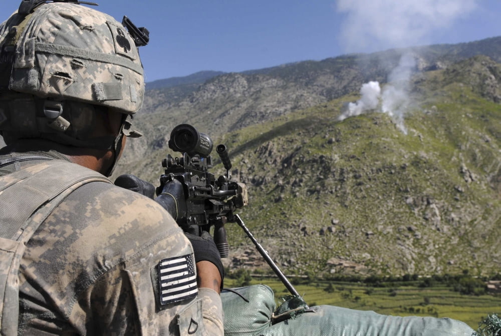 A US Army grenadier scans a nearby ridgeline at a mountaintop observation post in Afghanistan Canvas Art - Stocktrek Images (34 x 23)