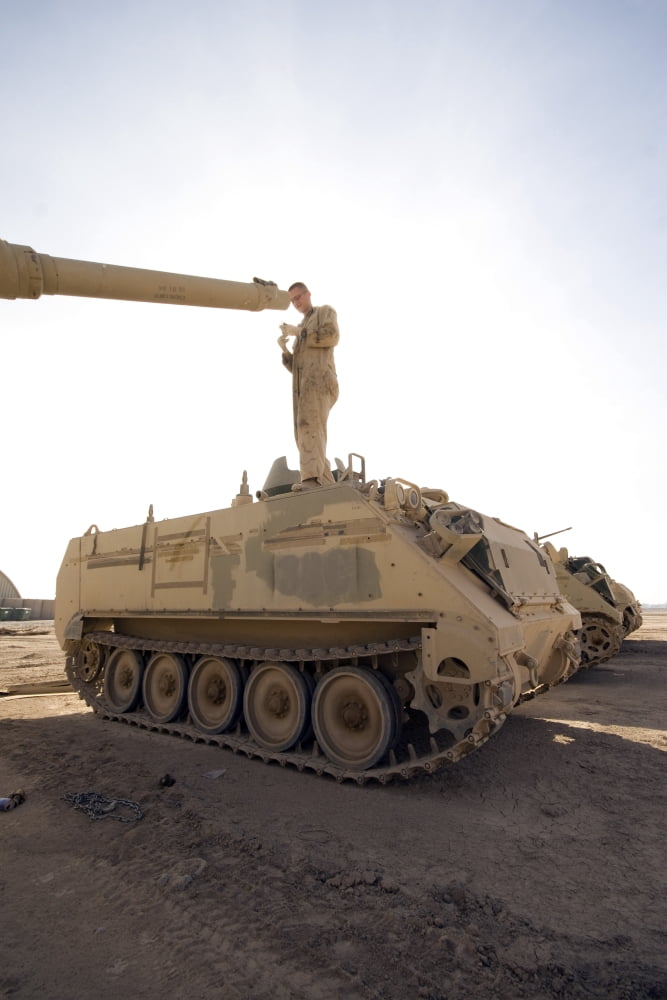 A US Army mechanic uses a M113 as a platform to boresight a M1 Abrams tank Canvas Art - Terry MooreStocktrek Images (12 x 18)