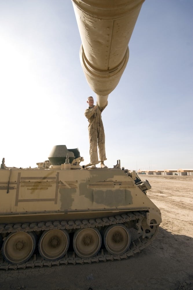 A US Army mechanic uses a M113 as a platform to boresight a M1 Abrams tank Canvas Art - Terry MooreStocktrek Images (23 x 35)